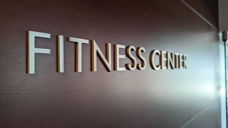 Fitness studio owner in a modern branded workspace, representing fitness business marketing that turns leads into...