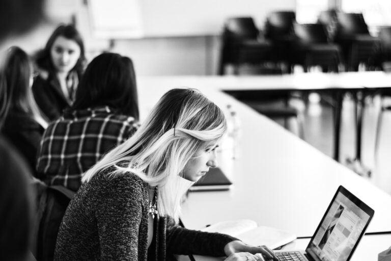 Student and teacher using a laptop in a modern classroom to illustrate AI use cases in education
